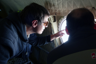 IceBridge project scientist Nathan Kurtz and Sebastián Marinsek from Instituto Antártica Argentino observe Larsen C from a window on the P-3 aircraft. (Image: NASA/Kathryn Hansen)